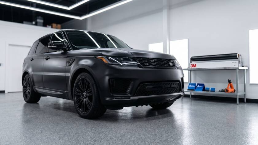 Matte black vinyl wrapped SUV inside MDM Auto Detail studio Richmond Hill