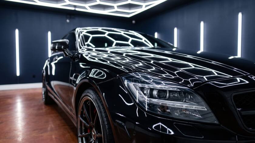 Close-up of a freshly ceramic coated black Mercedes reflecting LED lights at MDM Auto Detail Richmond Hill